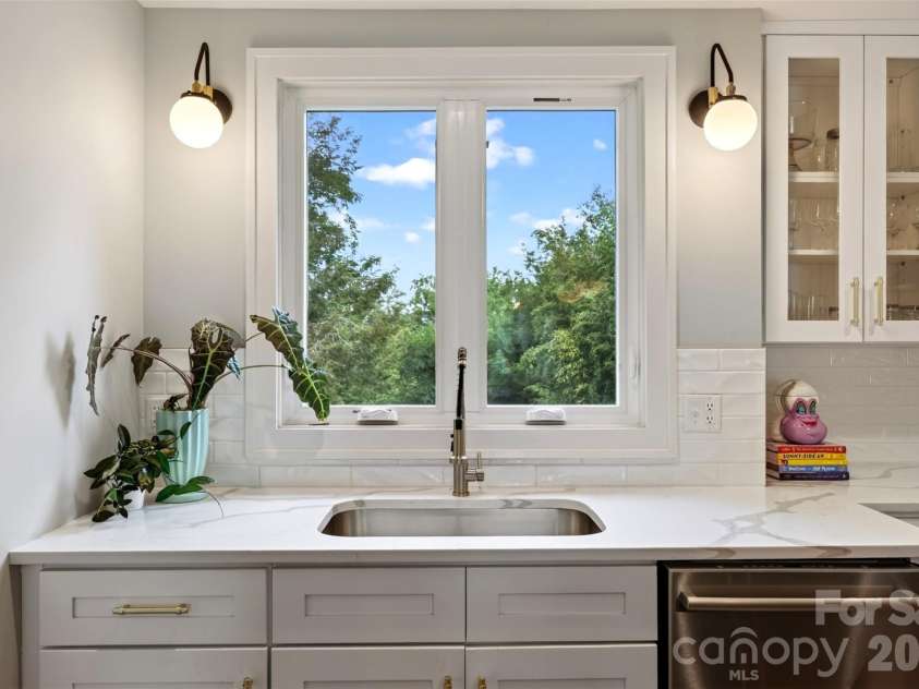 55 Edgemont Road, Asheville, NC 28801.  MLS# CAR4412693, YatesRealty ID 44449. Kitchen sink overlooking terraced back yard