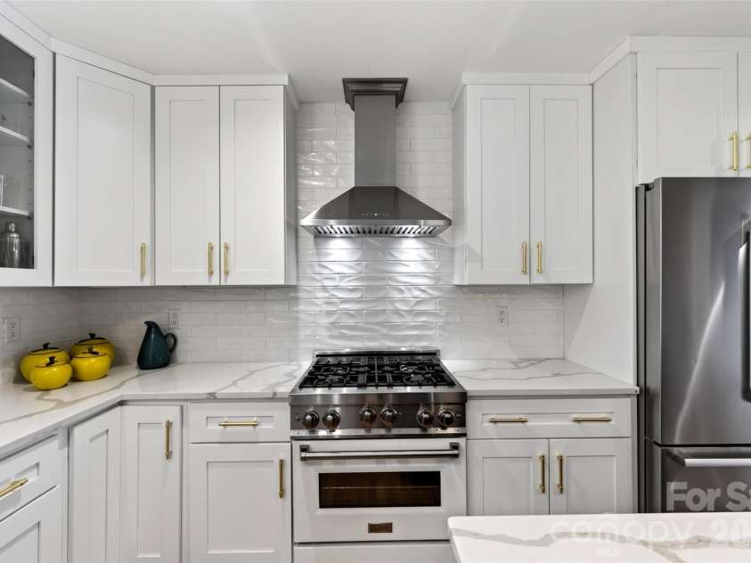 55 Edgemont Road, Asheville, NC 28801.  MLS# CAR4412693, YatesRealty ID 44449. Kitchen with custom cabinetry, range & refrigerator