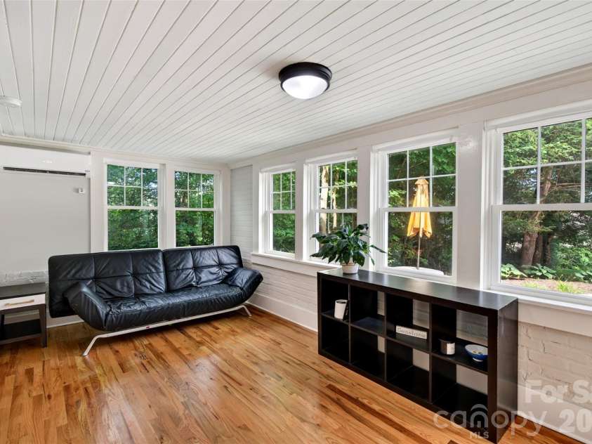 55 Edgemont Road, Asheville, NC 28801.  MLS# CAR4412693, YatesRealty ID 44449. Lower level living room facing terraced back yard