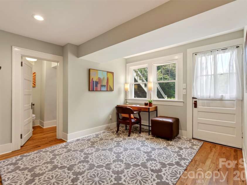 55 Edgemont Road, Asheville, NC 28801.  MLS# CAR4412693, YatesRealty ID 44449. Lower level study with bathroom  entry and back yard entry
