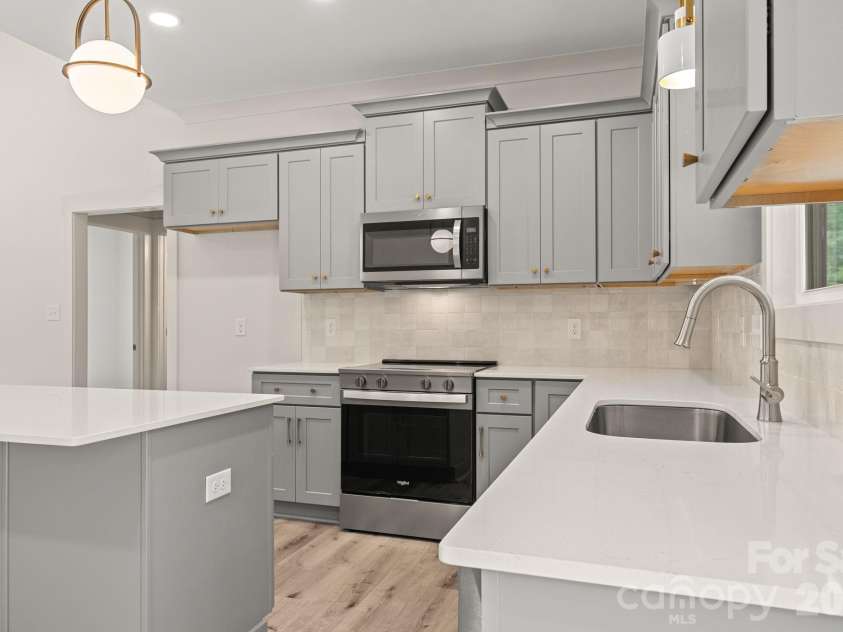 151 McCorkle Street, York, SC 29745.  MLS# CAR4414413, YatesRealty ID 44460. Kitchen - quartz counters & tiled backsplash