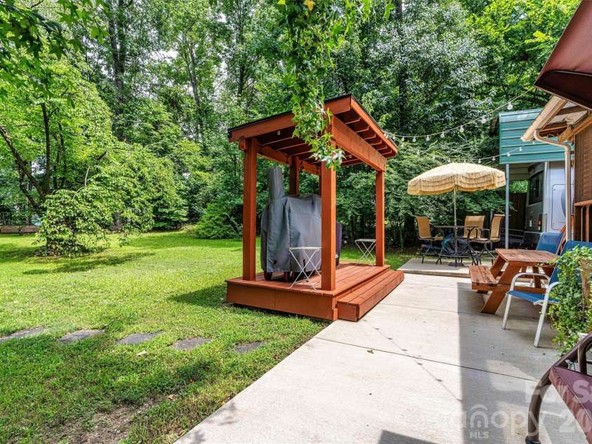 7697 Katherine Drive, Denver, NC 28037.  MLS# CAR4414395, YatesRealty ID 44462. Backyard landscape with Grill Canopy