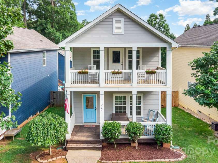 12304 Huntersville Concord Road, Huntersville, NC 28078.  MLS# CAR4268333, YatesRealty ID 4456. Charming Charleston-style exterior with beautiful double covered porches and welcoming blue door