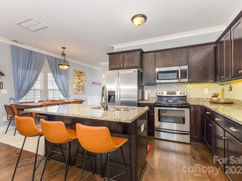 12304 Huntersville Concord Road, Huntersville, NC 28078.  MLS# CAR4268333, YatesRealty ID 4456. Open-concept kitchen with undercabinet lighting and dining area