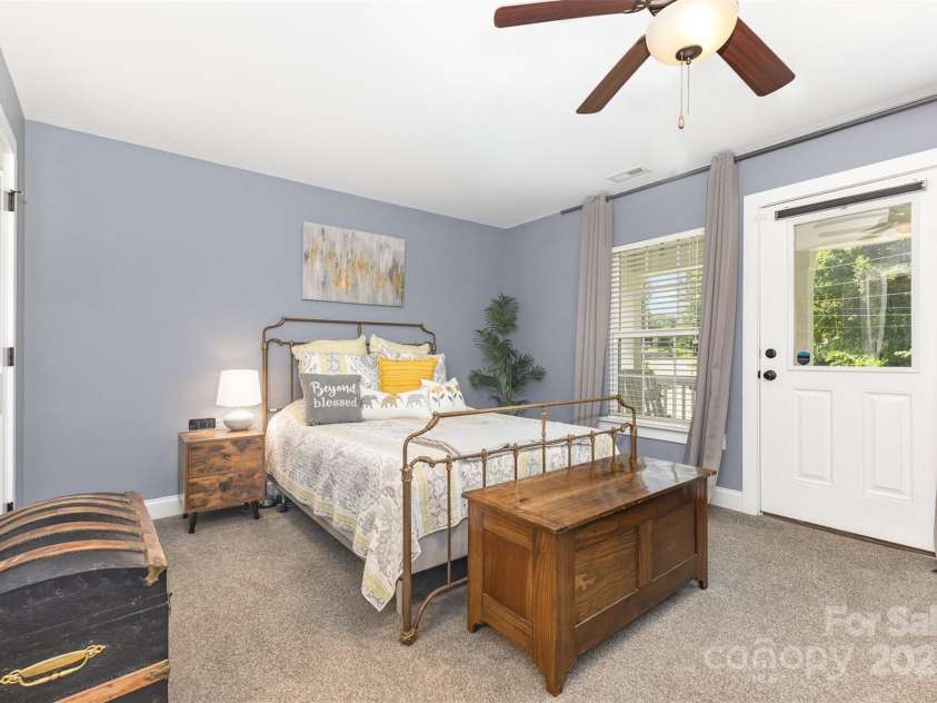 12304 Huntersville Concord Road, Huntersville, NC 28078.  MLS# CAR4268333, YatesRealty ID 4456. Primary bedroom with all of the amenities -  2 closets (1 walk-in closet, 1 traditional closet), ensuite full bath, access to covered balcony deck, sitting nook, and laundry just down the hall