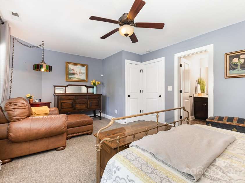 12304 Huntersville Concord Road, Huntersville, NC 28078.  MLS# CAR4268333, YatesRealty ID 4456. Primary bedroom with all of the amenities -  2 closets (1 walk-in closet, 1 traditional closet), ensuite full bath, access to covered balcony deck, sitting nook, and laundry just down the hall