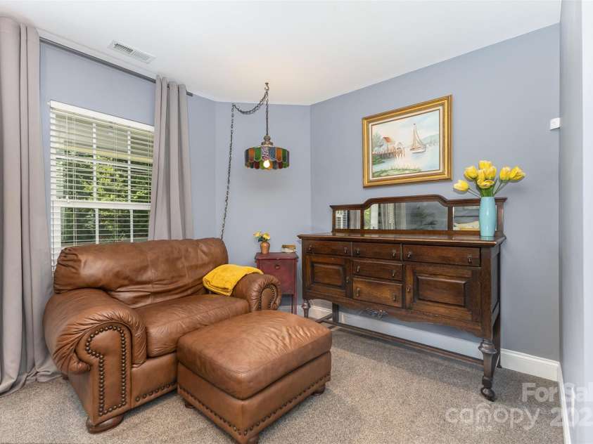 12304 Huntersville Concord Road, Huntersville, NC 28078.  MLS# CAR4268333, YatesRealty ID 4456. Primary bedroom with all of the amenities -  2 closets (1 walk-in closet, 1 traditional closet), ensuite full bath, access to covered balcony deck, sitting nook, and laundry just down the hall