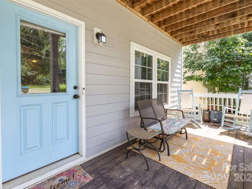 12304 Huntersville Concord Road, Huntersville, NC 28078.  MLS# CAR4268333, YatesRealty ID 4456. Rocking-chair ready front porch, with retractable gate on porch, and welcoming blue door. Matching rockers included for all of the southern charm!