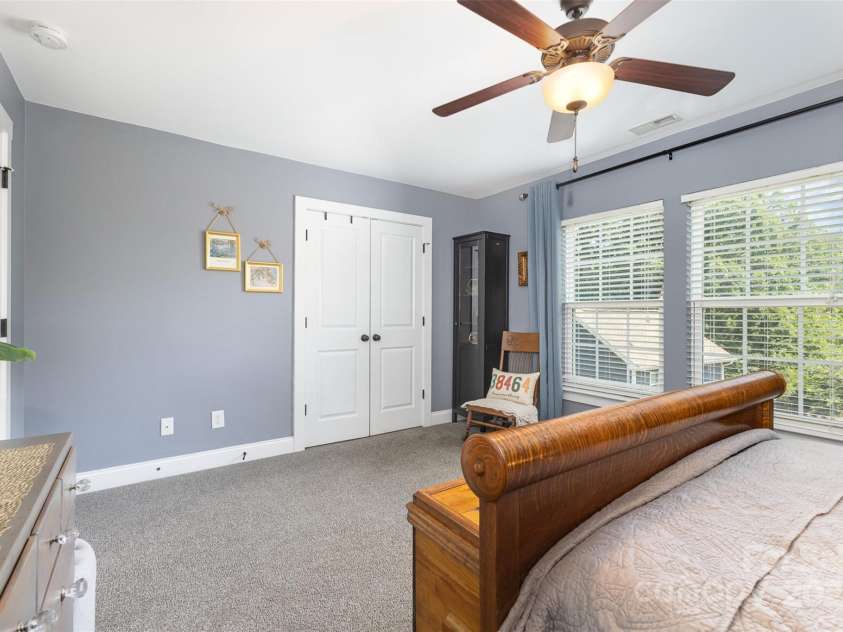 12304 Huntersville Concord Road, Huntersville, NC 28078.  MLS# CAR4268333, YatesRealty ID 4456. Upper level guest bedroom with double door closet and large windows