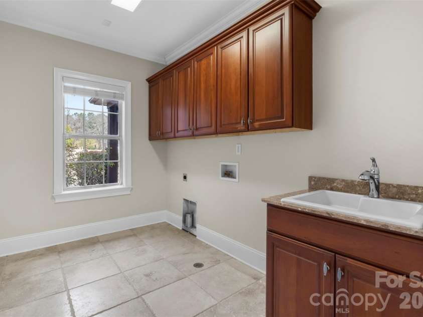 5164 Mill Race Lane, Lancaster, SC 29720.  MLS# CAR4342322, YatesRealty ID 4458. Laundry Room with Utility Sink and Custom Cabinetry on Main
