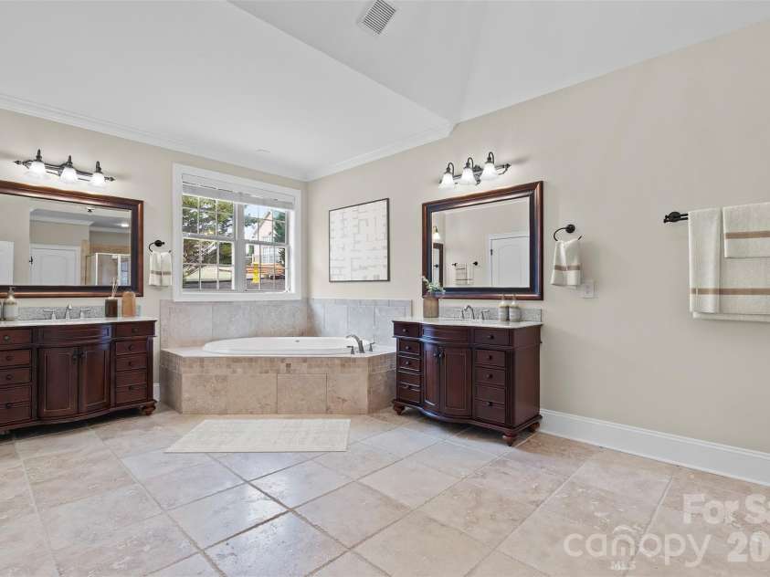 5164 Mill Race Lane, Lancaster, SC 29720.  MLS# CAR4342322, YatesRealty ID 4458. Spacious Primary Bath with Jacuzzi Tub and room for a dressing table or lounger (Virtually Staged)