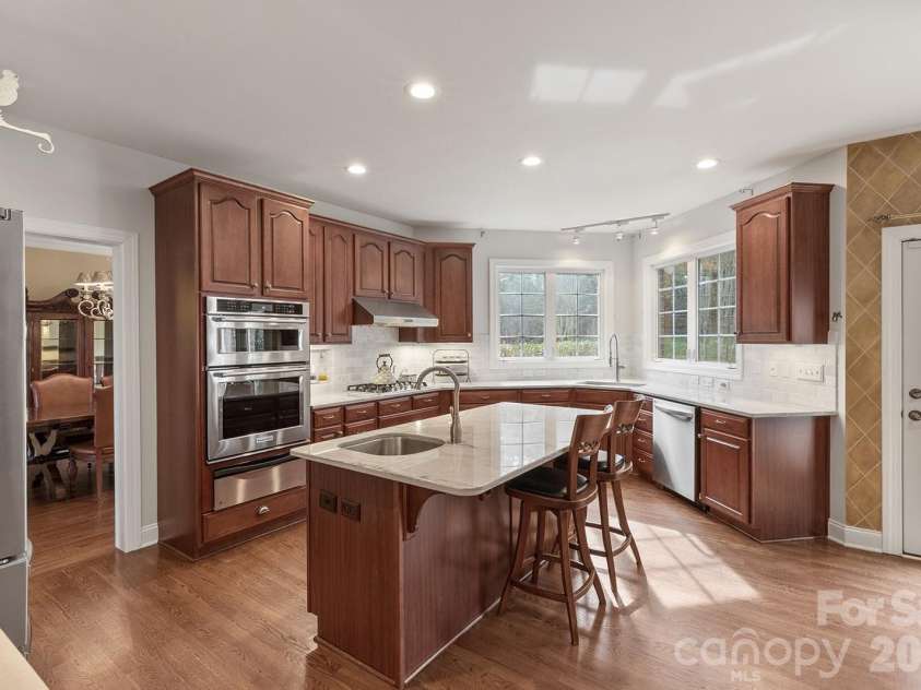 2310 Keara Way, Charlotte, NC 28270.  MLS# CAR4314530, YatesRealty ID 4460. The exhaust fan is made to accommodate high heat and will turn on on its own if it gets too hot - as the cooktop which has a high BTU in middle range and boils water super quick and great for stir fry.