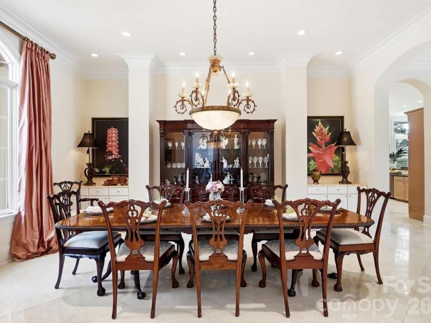 20124 Bascom Ridge Drive, Cornelius, NC 28031.  MLS# CAR4408389, YatesRealty ID 44623. From the foyer, the home opens naturally into its main entertaining spaces, creating an inviting flow from one room to the next. A wide arched opening leads to the formal dining room, while the central hall contin