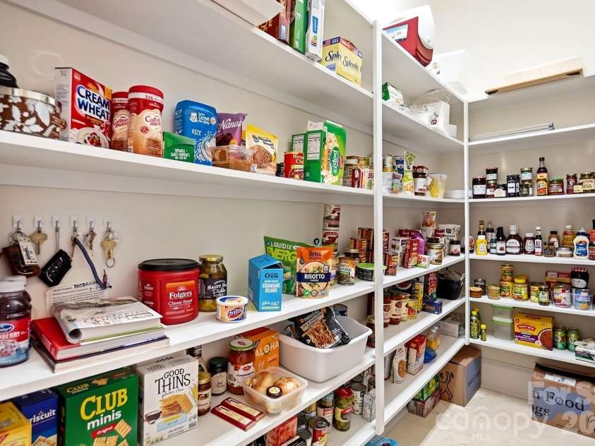 20124 Bascom Ridge Drive, Cornelius, NC 28031.  MLS# CAR4408389, YatesRealty ID 44623. Just off the kitchen, a generous walk-in pantry provides exceptional storage with extensive built-in shelving and room to keep everyday essentials neatly organized and easily accessible.