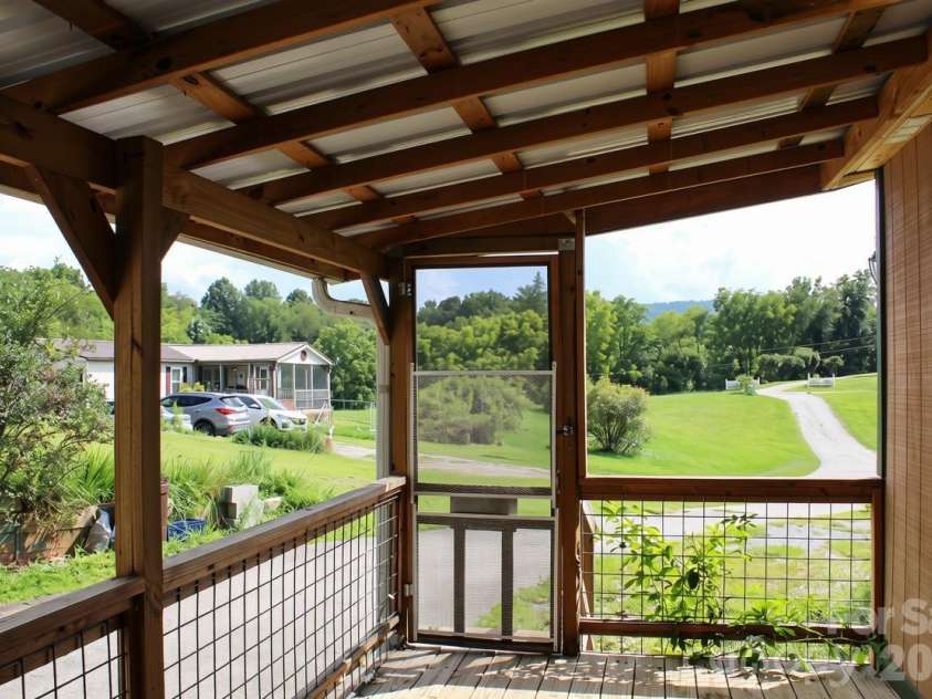 24 Karis Lane, Clyde, NC 28721.  MLS# CAR4414971, YatesRealty ID 44655. Back deck