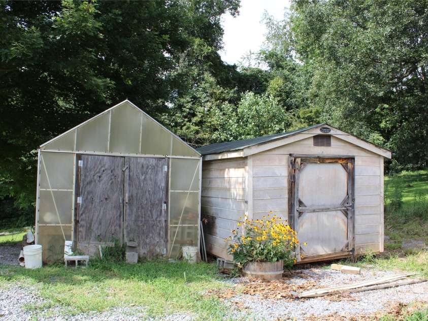 24 Karis Lane, Clyde, NC 28721.  MLS# CAR4414971, YatesRealty ID 44655. Greenhouse shed