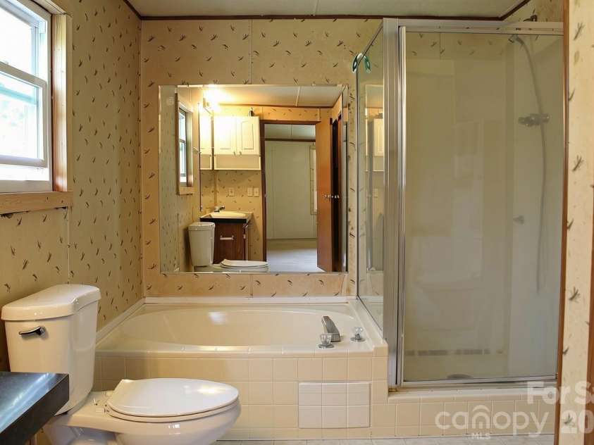 24 Karis Lane, Clyde, NC 28721.  MLS# CAR4414971, YatesRealty ID 44655. Primary bathroom