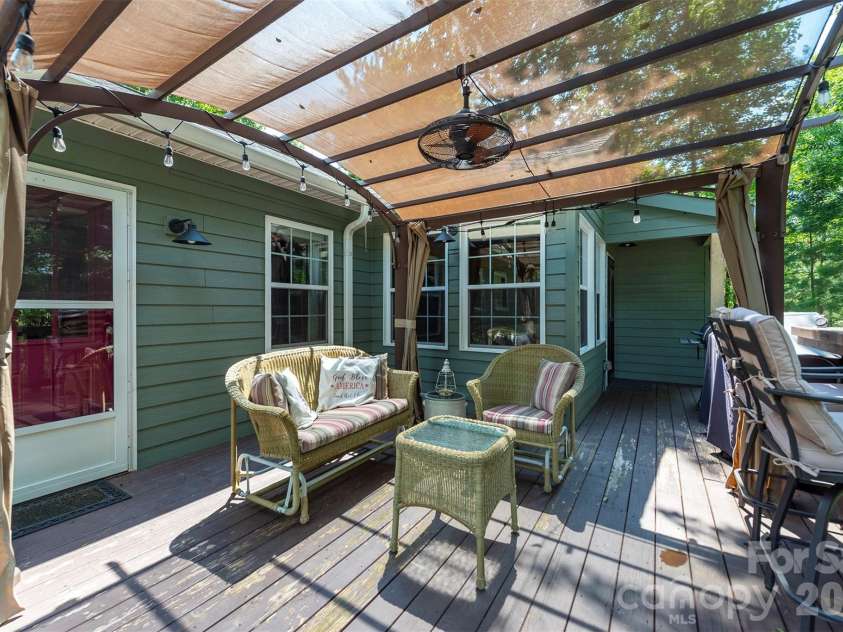 4895 Hudlow Road, Union Mills, NC 28167.  MLS# CAR4414979, YatesRealty ID 44656. Side deck with a few of the trees.