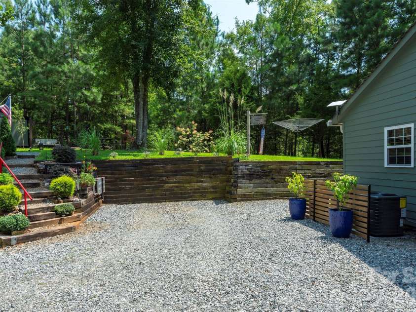 4895 Hudlow Road, Union Mills, NC 28167.  MLS# CAR4414979, YatesRealty ID 44656. Side view of cabin beautiful park setting
