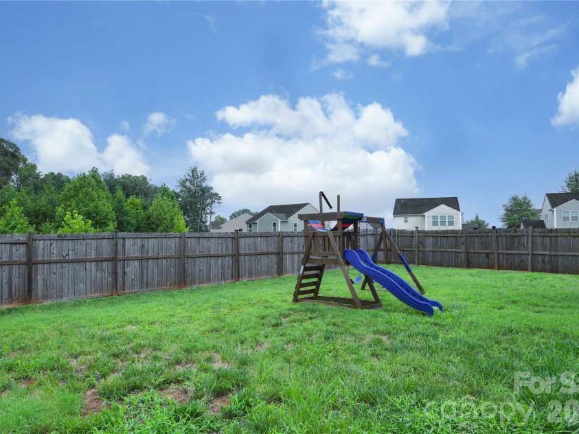 5149 Red Poll Drive, Greensboro, NC 27405.  MLS# CAR4411015, YatesRealty ID 44660. Backyard w/ Playset