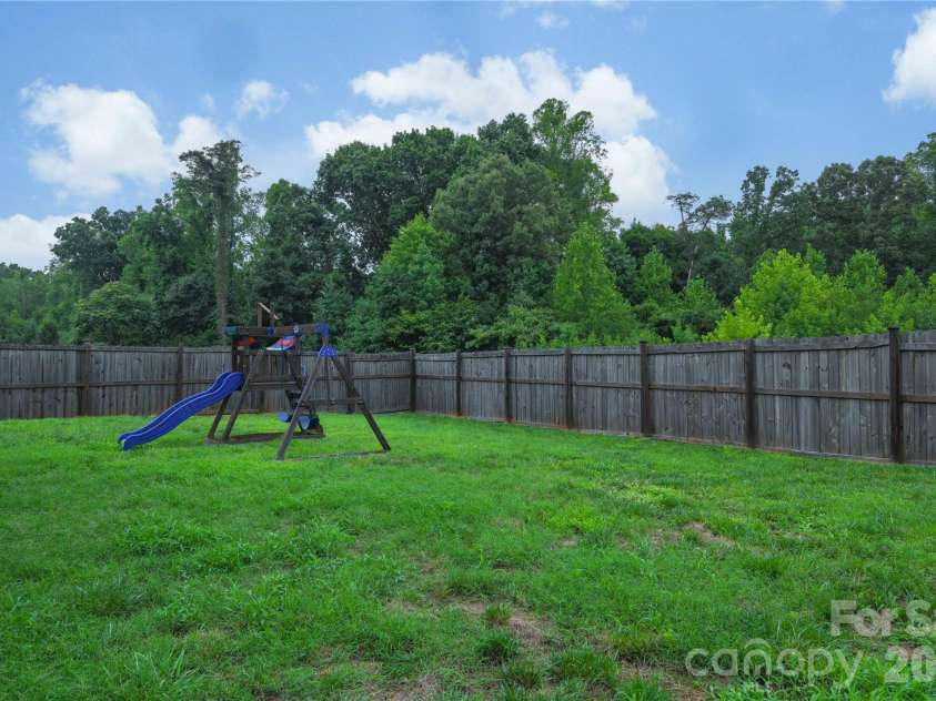 5149 Red Poll Drive, Greensboro, NC 27405.  MLS# CAR4411015, YatesRealty ID 44660. Backyard w/ Playset