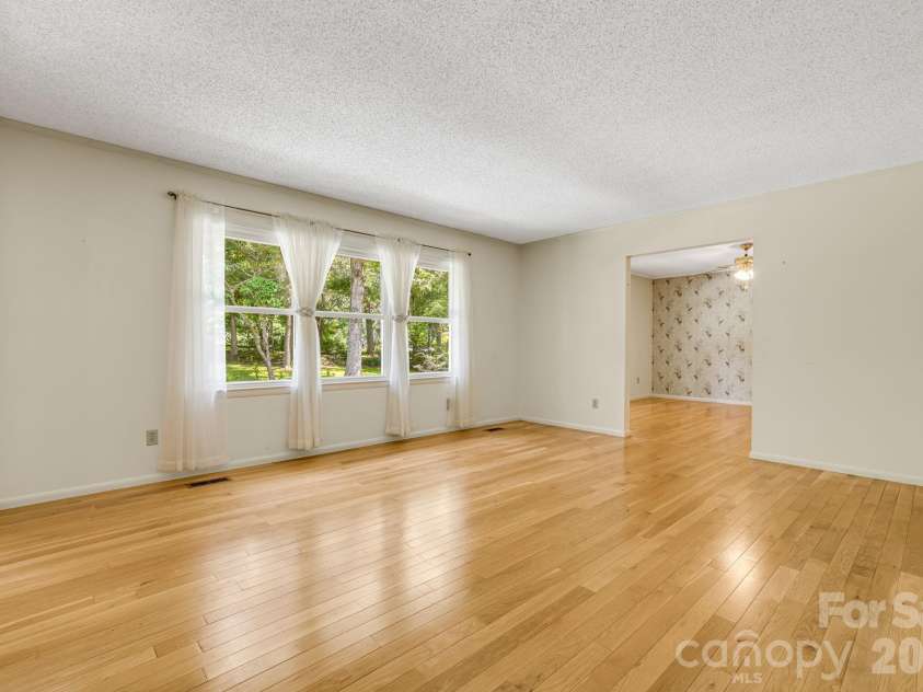 11 Ridgeway Drive, Weaverville, NC 28787.  MLS# CAR4414965, YatesRealty ID 44696. Living Room looking into Dining Room