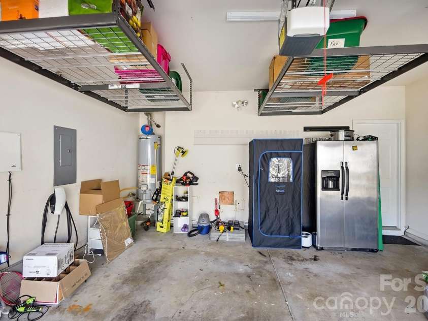 8530 Heron Glen Drive, Charlotte, NC 28269.  MLS# CAR4410893, YatesRealty ID 44779. Garage with extra storage & EV charging station