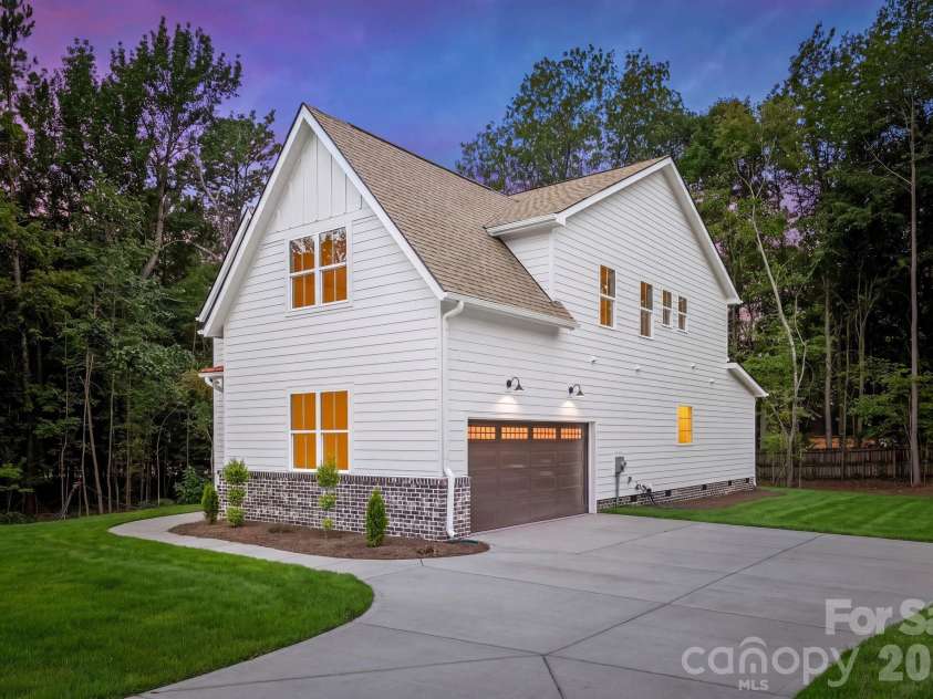 2311 Chateau Court, Matthews, NC 28105.  MLS# CAR4407256, YatesRealty ID 44799. Side exterior view at twilight.