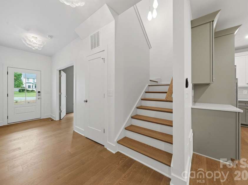 2311 Chateau Court, Matthews, NC 28105.  MLS# CAR4407256, YatesRealty ID 44799. Stairwell to upper level.