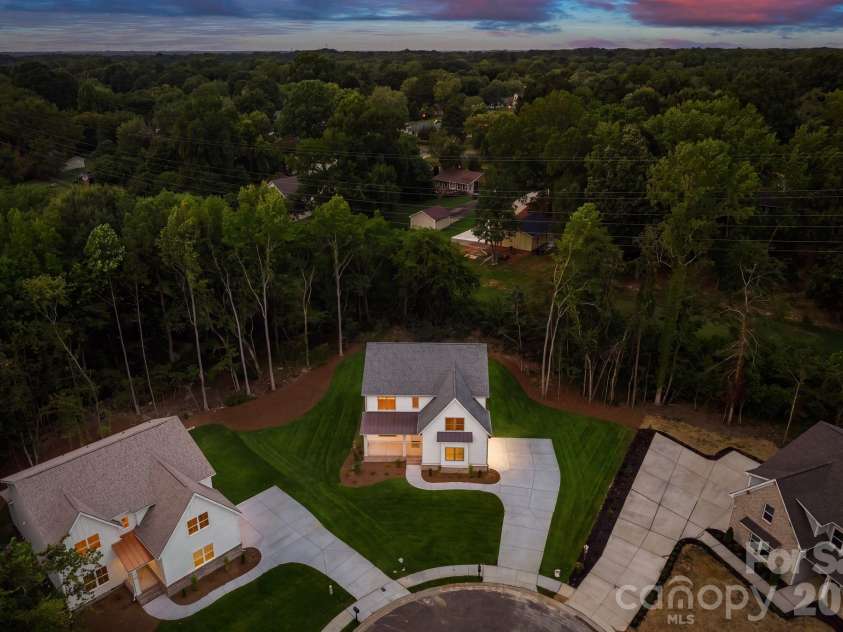 2315 Chateau Court, Matthews, NC 28105.  MLS# CAR4407259, YatesRealty ID 44800. Aerial twilight view.
