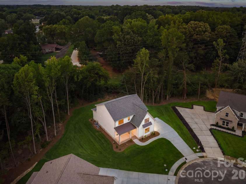 2315 Chateau Court, Matthews, NC 28105.  MLS# CAR4407259, YatesRealty ID 44800. Aerial twilight view.