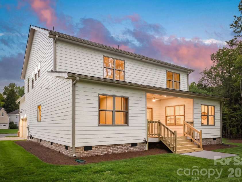 2315 Chateau Court, Matthews, NC 28105.  MLS# CAR4407259, YatesRealty ID 44800. Exterior side view at twilight.