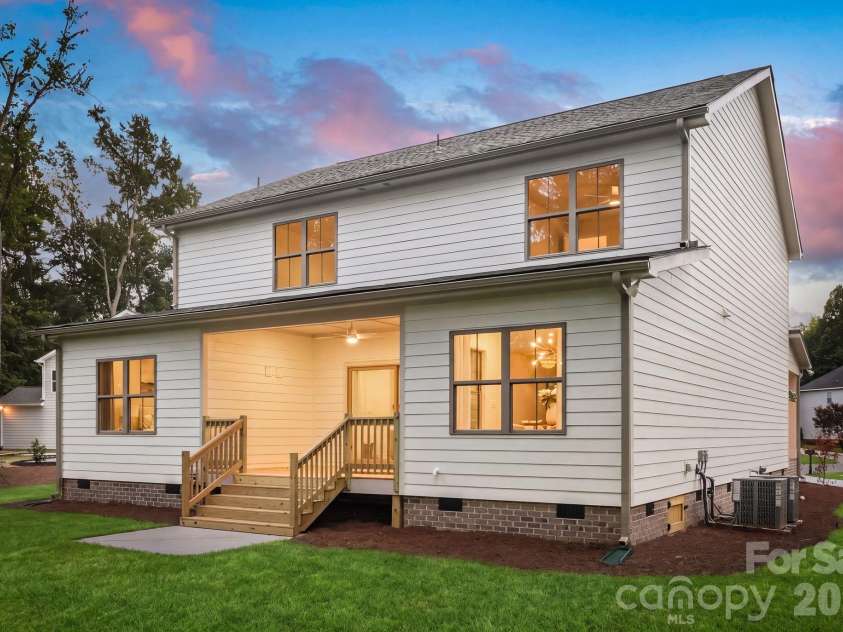 2315 Chateau Court, Matthews, NC 28105.  MLS# CAR4407259, YatesRealty ID 44800. Exterior side view at twilight.