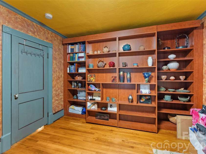 620 Old Lytle Cove Road, Swannanoa, NC 28778.  MLS# CAR4415136, YatesRealty ID 44806. 2nd bedroom with rolling shelves hiding a murphy bed
