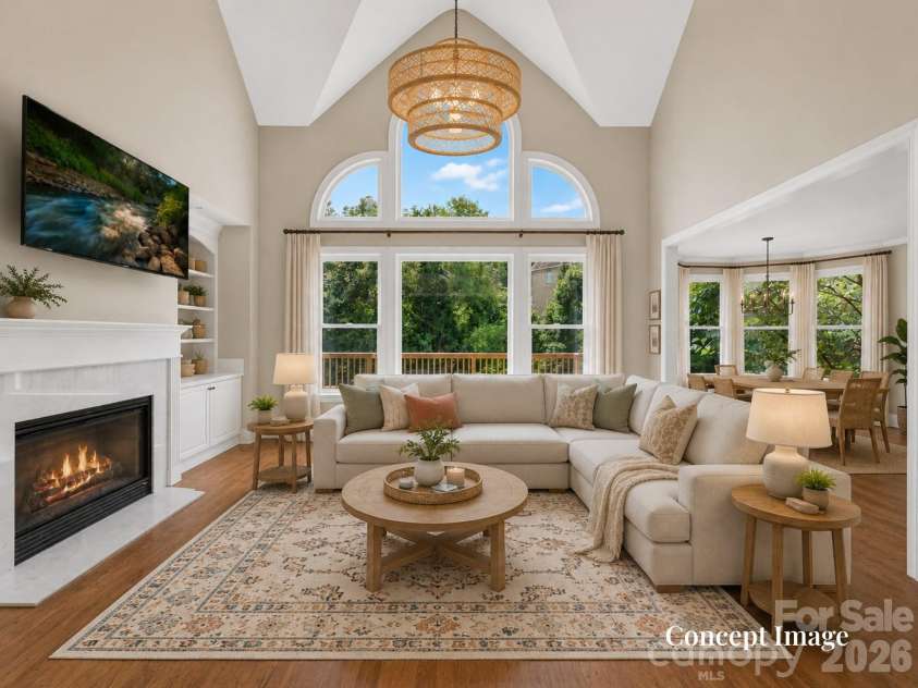447 Three Greens Drive, Huntersville, NC 28078.  MLS# CAR4414048, YatesRealty ID 44824. Concept Photo (virtually staged) - Dramatic two-story great room features a fireplace with built-ins, soaring windows, hardwood floors, and abundant natural light.