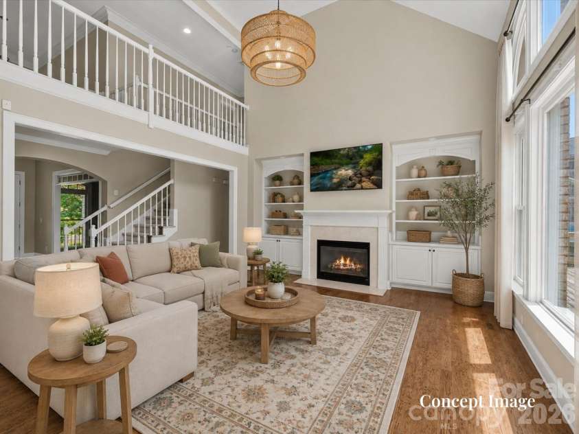 447 Three Greens Drive, Huntersville, NC 28078.  MLS# CAR4414048, YatesRealty ID 44824. Concept Photo (Virtually staged)- Impressive two-story great room features soaring ceilings, a cozy fireplace with built-ins, hardwood floors, and abundant natural light from expansive windows.