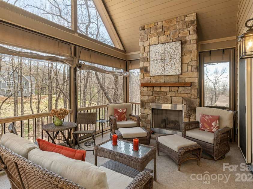 23 Dartmoor Court, Flat Rock, NC 28731.  MLS# CAR4241308, YatesRealty ID 4483. Screened Porch with Fireplace