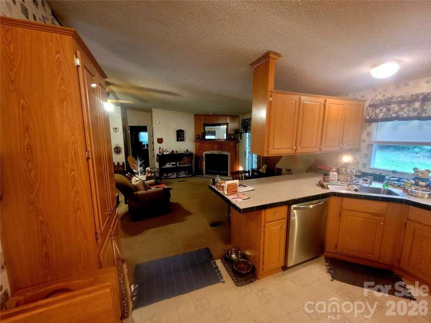 121 Sylvan Drive, Statesville, NC 28677.  MLS# CAR4414812, YatesRealty ID 44831. Kitchen and den