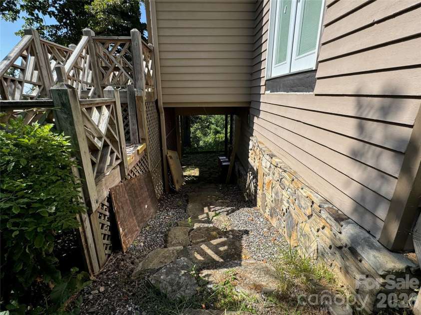 87 Island In The Sky Trail, Weaverville, NC 28787.  MLS# CAR4415059, YatesRealty ID 44940. Walkway under Office Space to lower level under deck and Entry.