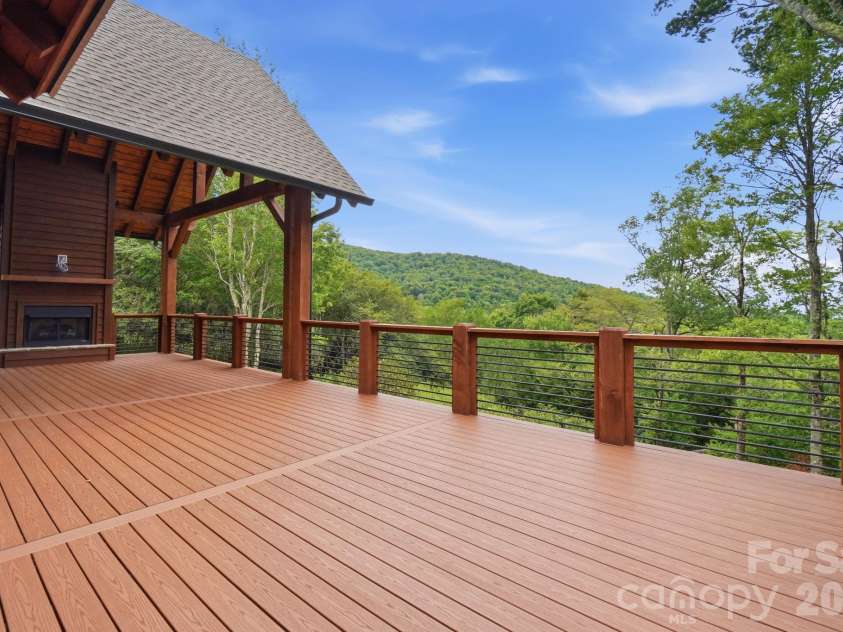 761 Foxfire Drive, Banner Elk, NC 28604.  MLS# CAR4415541, YatesRealty ID 45002. Covered back patio perfect for relaxing and enjoying the wooded setting.