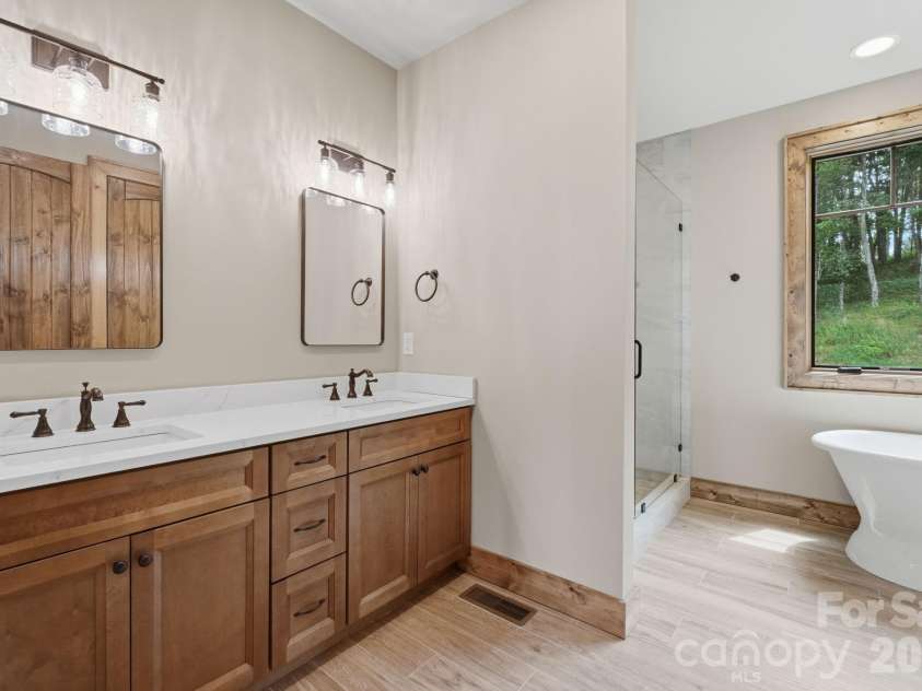 761 Foxfire Drive, Banner Elk, NC 28604.  MLS# CAR4415541, YatesRealty ID 45002. Owners retreat bath features a spacious layout with a walk-in shower and double vanity.