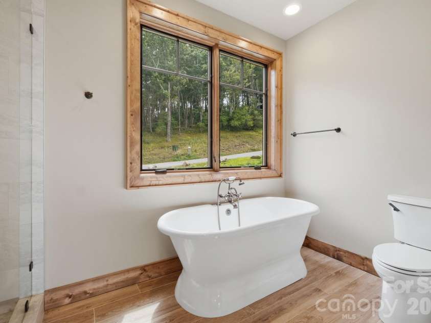 761 Foxfire Drive, Banner Elk, NC 28604.  MLS# CAR4415541, YatesRealty ID 45002. Owners retreat bath features a spacious layout with a walk-in shower and double vanity.