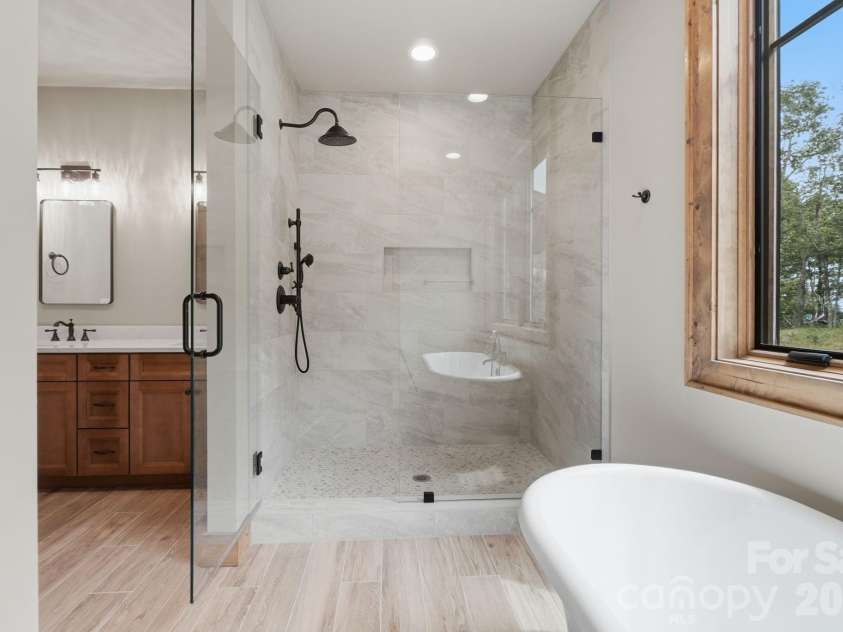 761 Foxfire Drive, Banner Elk, NC 28604.  MLS# CAR4415541, YatesRealty ID 45002. Owners retreat bath features a spacious layout with a walk-in shower and double vanity.