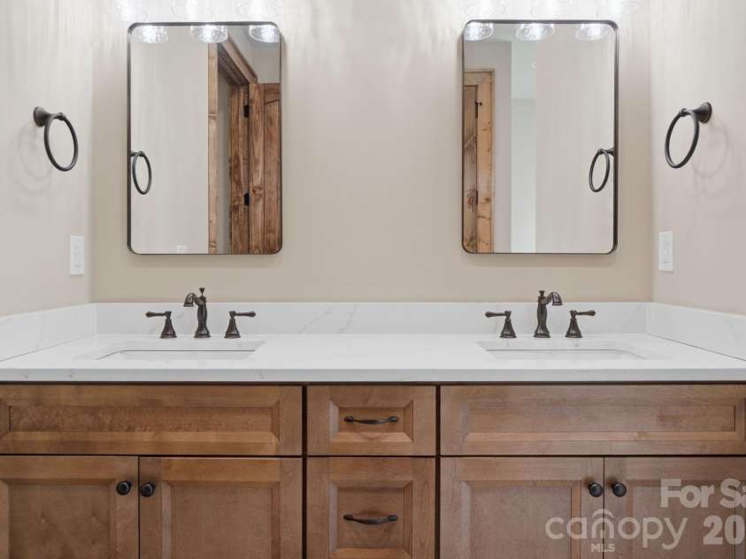 761 Foxfire Drive, Banner Elk, NC 28604.  MLS# CAR4415541, YatesRealty ID 45002. Owners retreat bath features a spacious layout with a walk-in shower and double vanity.