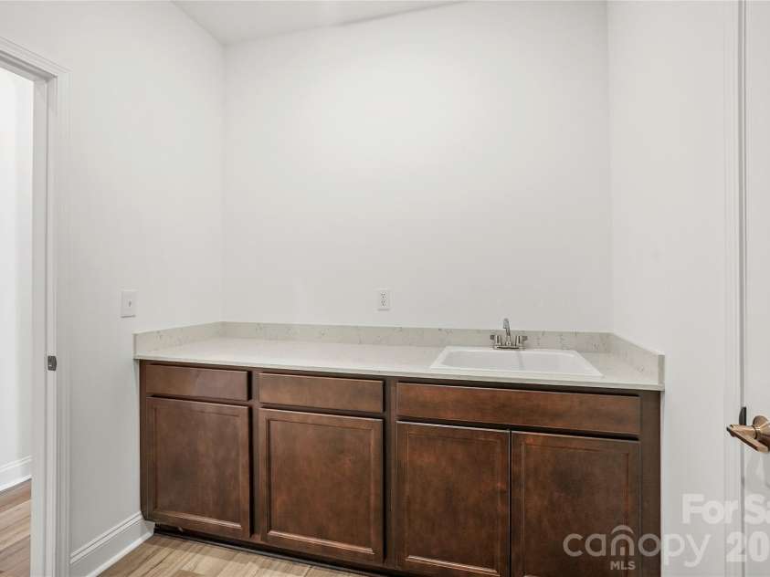 7512 Pedigree Circle, Lancaster, SC 29720.  MLS# CAR4415688, YatesRealty ID 45068. Spacious laundry room with cabinets, countertop, and sink package