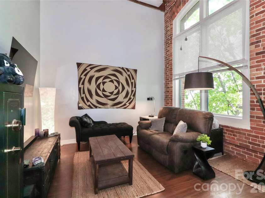 201 Hoskins Road, Charlotte, NC 28208.  MLS# CAR4341701, YatesRealty ID 4509. The 2-story living room is the standout feature. Its volume, openness, and huge proportions make a huge difference to this condo.