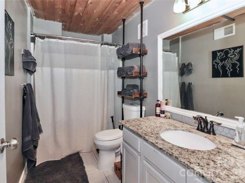201 Hoskins Road, Charlotte, NC 28208.  MLS# CAR4341701, YatesRealty ID 4509. The bathroom has everything from great design to quality, reliable fixtures and beautiful lighting.
