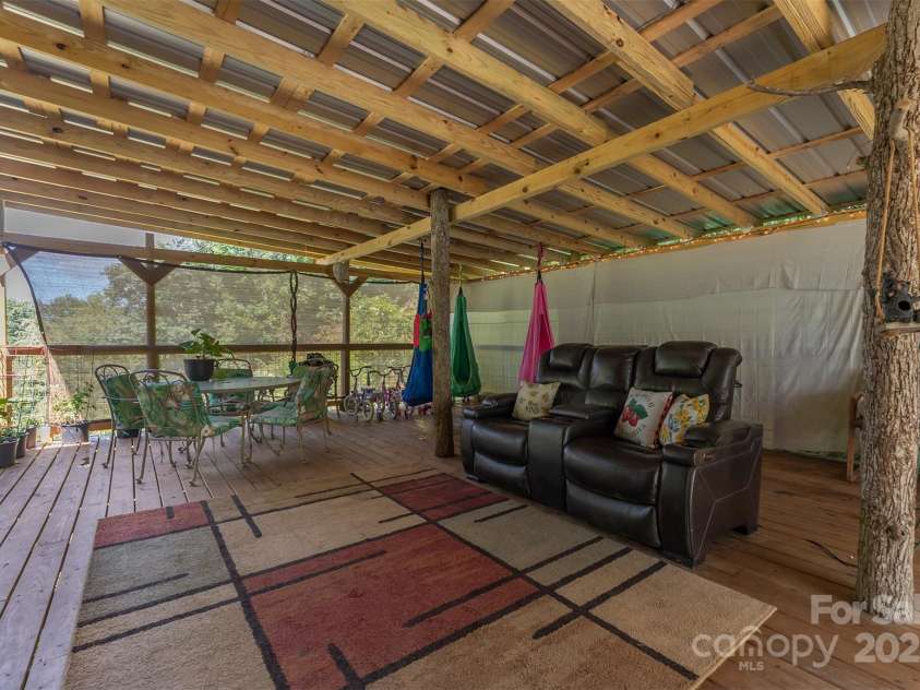 1145 Woolyshot Branch Road, Hot Springs, NC 28743.  MLS# CAR4295648, YatesRealty ID 451. Covered side porch. 