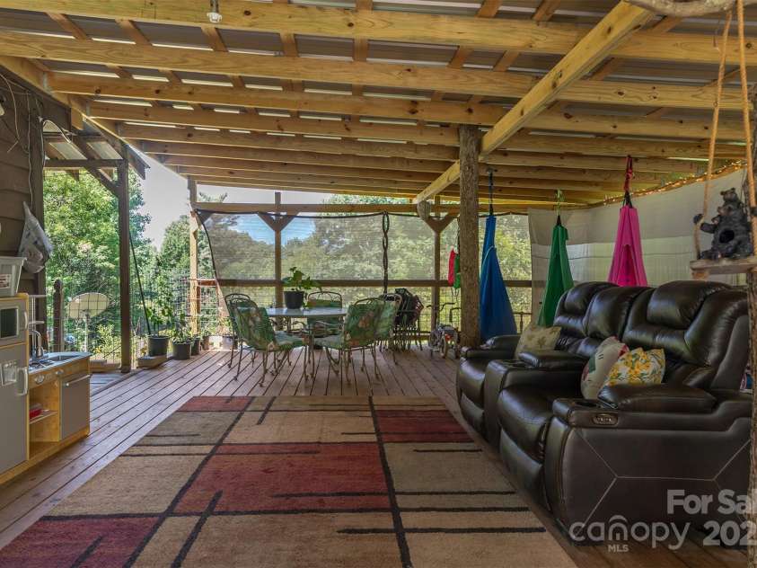 1145 Woolyshot Branch Road, Hot Springs, NC 28743.  MLS# CAR4295648, YatesRealty ID 451. Covered side porch. 