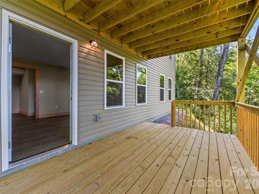 212 Brigsy Lane, Whittier, NC 28789.  MLS# CAR4391142, YatesRealty ID 451. Lower deck off family room